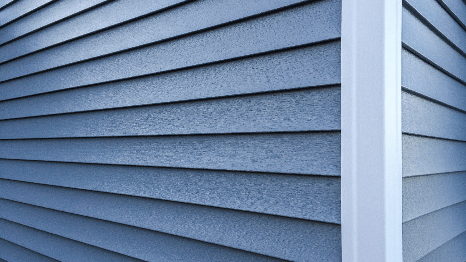 Professional blue vinyl siding installation by In-Vision Construction